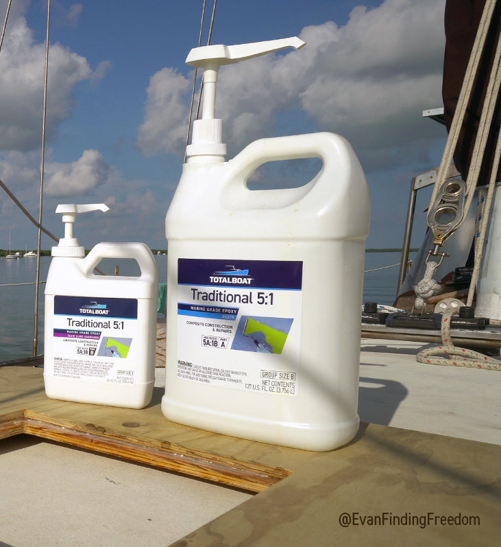 Traditional 5:1 Marine Epoxy bottles with pumps on the deck of a sailboat. The epoxy is being used to adhere two pieces of marine-grade plywood with a hatch cut out. It's all hapening out on the water.