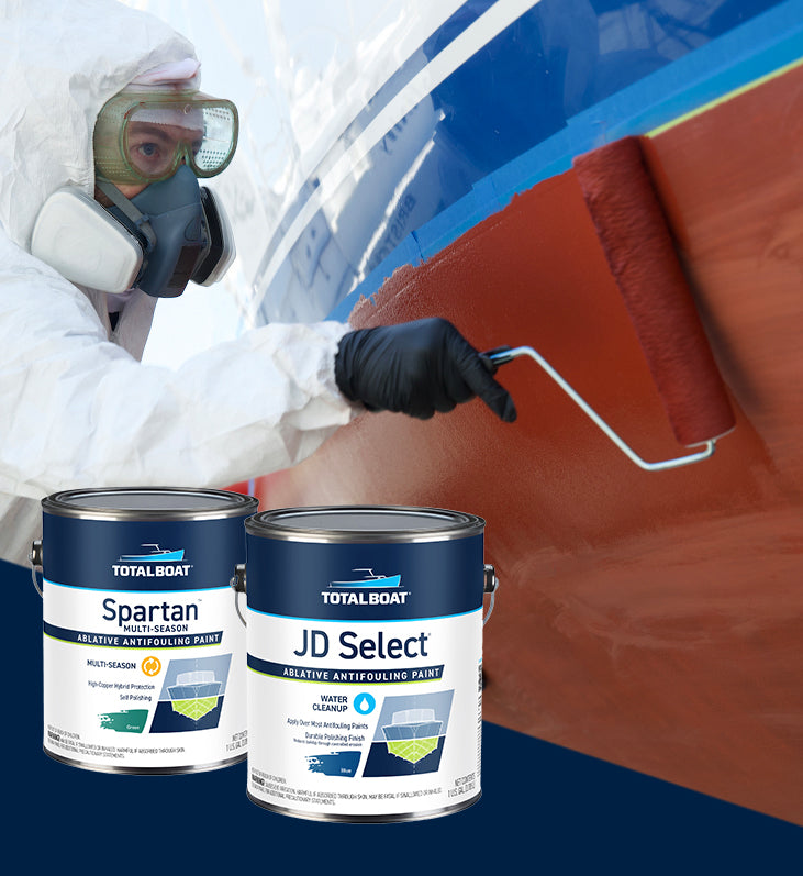 A do-it-yourself boater maintaining his sailboat with the application of TotalBoat Antifouling Paint before putting the boat in for the season. TotalBoat JD Select Ablative Antifouling Bottom Paint, TotalBoat Spartan Ablative Antifouling Paint and Underdog Ablative Antifouling bottom paint cans are showcased in the frame, in front of the photo.