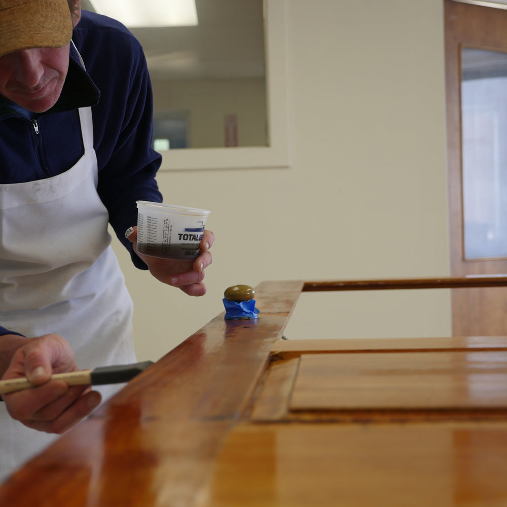 TotalBoat Wood Sealer Varnish Primer applied to wood with a brush